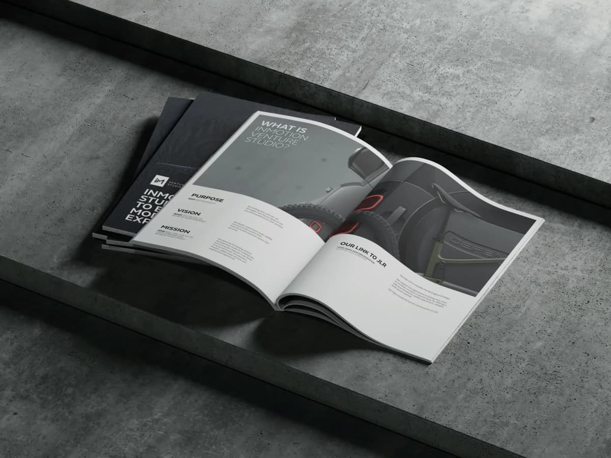 The printed InMotion Venture Studio playbook open on concrete at the purpose, vision and mission spread