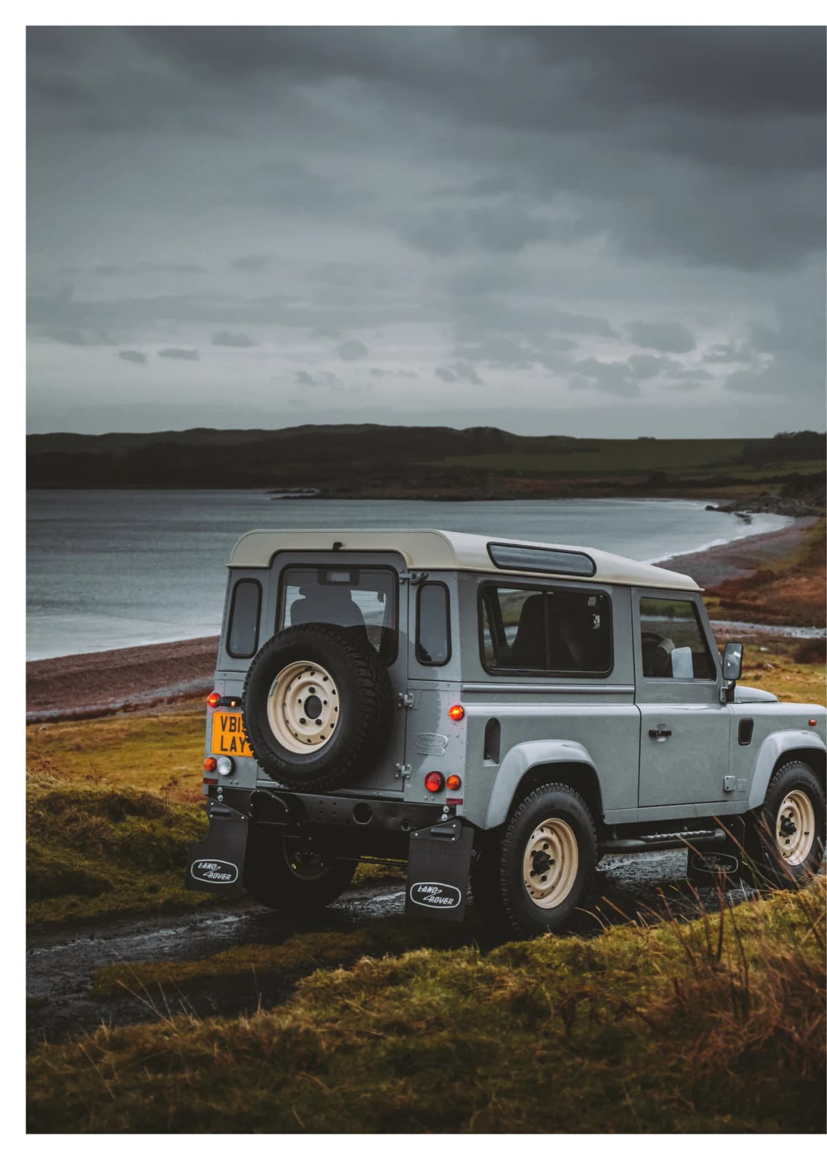 Playbook page: a classic Land Rover Defender on a coastal track under a stormy sky