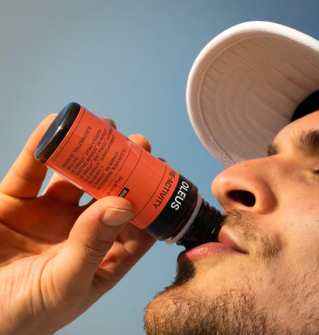 A cyclist drinking an OLEUS shot